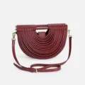 Burgundy leather half-moon shoulder bag with unique ribbed tubular design and metal hardware. - Burgundy
