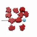 Detail view of 20mm maple leaf shaped wooden beads for DIY handmade jewelry crafts. - Dark Red