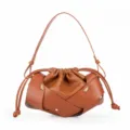 Brown leather shoulder bag for women, stylish pleated design with crossbody strap and gold knots. - Caramel color