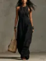 Detailed shot of a black sleeveless linen-blend jumpsuit with woven bag and accessories. - S / White