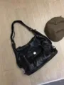Black soft leather slouchy shoulder bag with multi-pocket design and adjustable strap for daily use. - Black