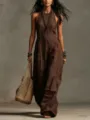 Detailed view of the elegant halter neckline and premium linen-texture fabric on this jumpsuit. - Coffee