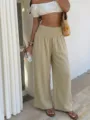 Detail view of casual resort wide-leg pants featuring high pleated elastic waist design. - Apricot