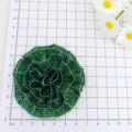 Detailed view of the green rhinestone fabric flower accessory, showing precise sizing on grid. - Green Flower Style (260802B)