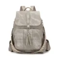 Grey washed canvas backpack variant with ethnic woven strap and chic tassel charm design. - Gray