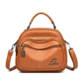 Brown leather women shoulder bag with multi zipper design and elegant top handle. - Orange