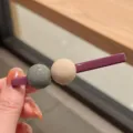 Detailed view of candy color hair clip with dual beads, chic style hair accessory for daily wear. - Deep purple