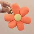 Close-up detail of the orange fabric flower hair claw clip showing soft petal texture. - Orange
