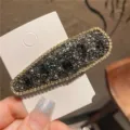 Detailed shot of sparkling rhinestone crystal hair clip in black and grey elegant design. - Teardrop / Glossy Gray