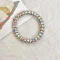 Clear telephone wire hair tie with colorful stars detail shot showing vibrant and playful design. - Star Style