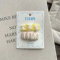 Close-up detail shot of the sweet fabric hair clip set featuring lace bows and striped design. - Bow Tie Pair