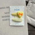 Close-up detail of cream yellow fabric hair clip set with cute heart and plaid design. - Heart Pair