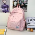 Charmant sac à dos rose à pois avec des motifs de nœuds mignons, idéal pour l'usage quotidien. - Rose