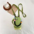 Stylish green mini crossbody bag with colorful woven strap for women daily outdoor use. - Green