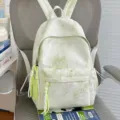 Zaino casual da studente verde chiaro con motivo a stelle e ciondoli nappa eleganti. - Taglia L / Verde