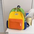 Colorful kids school backpack with vibrant color blocking design, front and side pockets. - Yellow