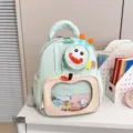 Cute mint green cartoon monster kindergarten backpack with transparent front pocket for kids. - Green