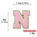 Toppa ciniglia lettera N rosa, distintivo ricamato autoadesivo con bordo glitter dorato. - Lettera N / Rosa / Autoadesivo