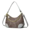 Detailed view of fashionable brown crocodile pattern hobo shoulder bag with chic gold chain. - Coffee