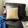 Decorative square throw pillow with black pom poms and colorful geometric border for sofa decor. - Sea Salt Frame Black Pom-pom
