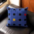 Detalle de cojín geométrico azul con patrón de cuadrícula negra y cuadrados de colores en el sofá. - Doble Cara 35x35cm (Funda Sin Relleno) / Cuadrado Azul Oscuro