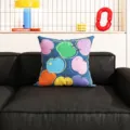 Detailaufnahme des bunten abstrakten Fruchtmuster Zierkissens auf einem modernen Sofa platziert. - Dunkelblau Frisches Obst