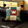Close-up view of retro style cartoon animal decorative throw pillow with chic black pom-poms. - Umbrella Post Black Pom-Pom