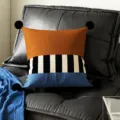 Detailed view of modern color block decorative throw pillow with corner pom-poms for couch - 35x35cm Pillowcase Without Core / Brown Stripe Black Pom-Pom