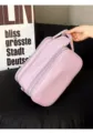 Detail shot of a large capacity purple PU leather cosmetic bag with double zipper and handle. - Makeup Bag / Taro Purple