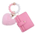 Detailed view of pink card holder with silicone bead bracelet and cute plush heart charm. - Rose Red