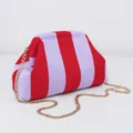 Close-up detail of the red and purple striped knit clutch bag with shiny gold chain. - Thick Striped / Red And Purple Stripes