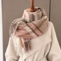 Detailed view of winter plaid fringe scarf texture close up warm wool feel fabric - Nude Pink