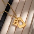 Gold stainless steel letter B pendant detail shot, stylish geometric cutout necklace close up. - X961