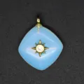 Closeup of a elegant light blue diamond pendant featuring a gold sunburst star crystal detail. - Opal