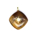 Detailed shot of rhombus crystal pendant featuring golden starburst setting and natural stone. - Multicolor