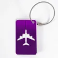 Purple aluminum alloy luggage tag with steel wire cable loop and airplane cutout design. - Purple