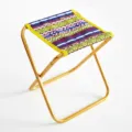 Portable folding camping stool with geometric patterned fabric and gold aluminum frame. - Ethnic Purple