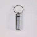 Portable aluminum emergency pill capsule with keyring, silver metal waterproof pill box for daily use. - Silver