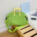 Large capacity expandable travel duffel bag in green with yellow handles and shoulder strap. - Green
