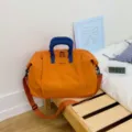 Large capacity travel bag waterproof weekender bag orange with blue handles for fitness and travel - Orange