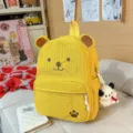 Cute yellow corduroy bear backpack with adorable cartoon ears, large capacity for daily school. - With Charm / Yellow