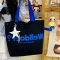 Large capacity black canvas tote bag with blue handles and stylish letter print for women. - Black