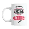 Close-up detail shot of a white ceramic coffee mug featuring custom phlebotomist typography. - 301-400ml / 6