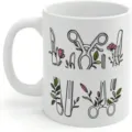 White ceramic coffee mug featuring medical surgical tools and floral botanical illustration. - 301-400ml / Medical Plant Illustration Print / White