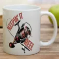 White ceramic coffee mug with fishing reel graphic print detail for office desk use. - 301-400ml / Style 8