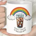 Detailed shot of a white ceramic coffee mug featuring a cute iced coffee and rainbow print. - Style 3