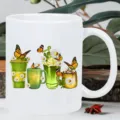 Close-up detail of white ceramic coffee mug featuring vibrant floral and butterfly printed design. - Style 6