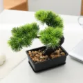 Artificial bonsai tree detail, small fake green plant in black pot for home decor. - Banyue Pine