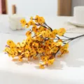 Artificial yellow flower branch detail view, perfect for home decor and floral arrangements. - Sunset