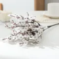 Detailed shot of artificial white plum blossom branch fake silk flower for home decor - White
